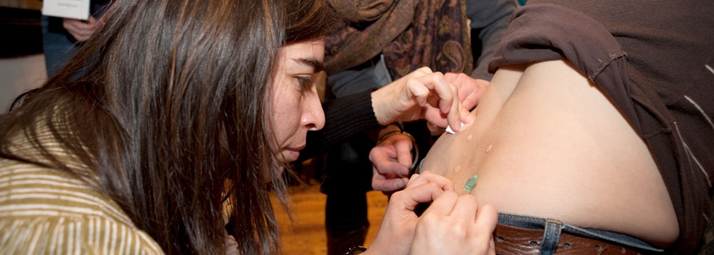 Practicing saline injections at a professional development event
